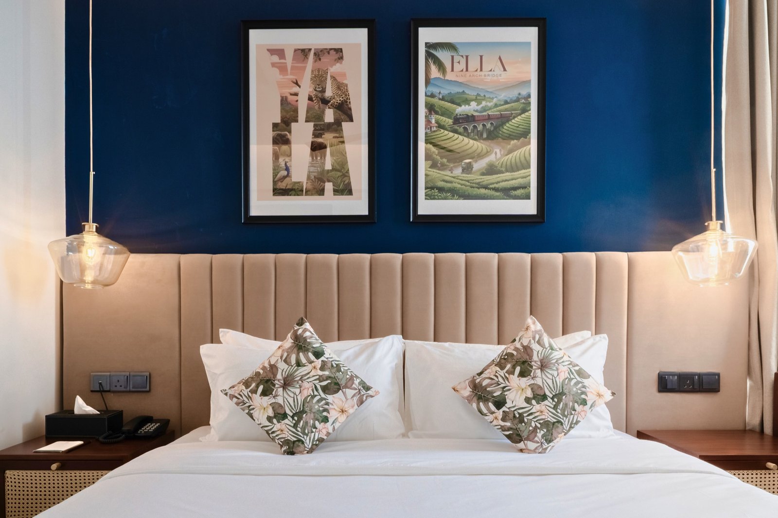 Deluxe Double Room bed and blue feature wall