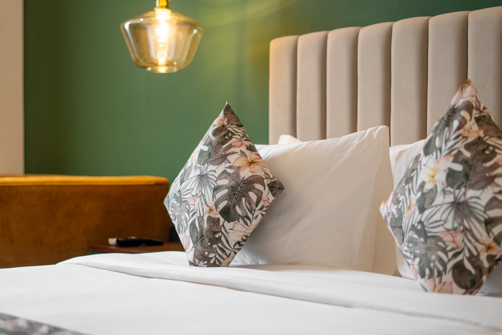 Guest bed and botanical cushions at MK Colombo