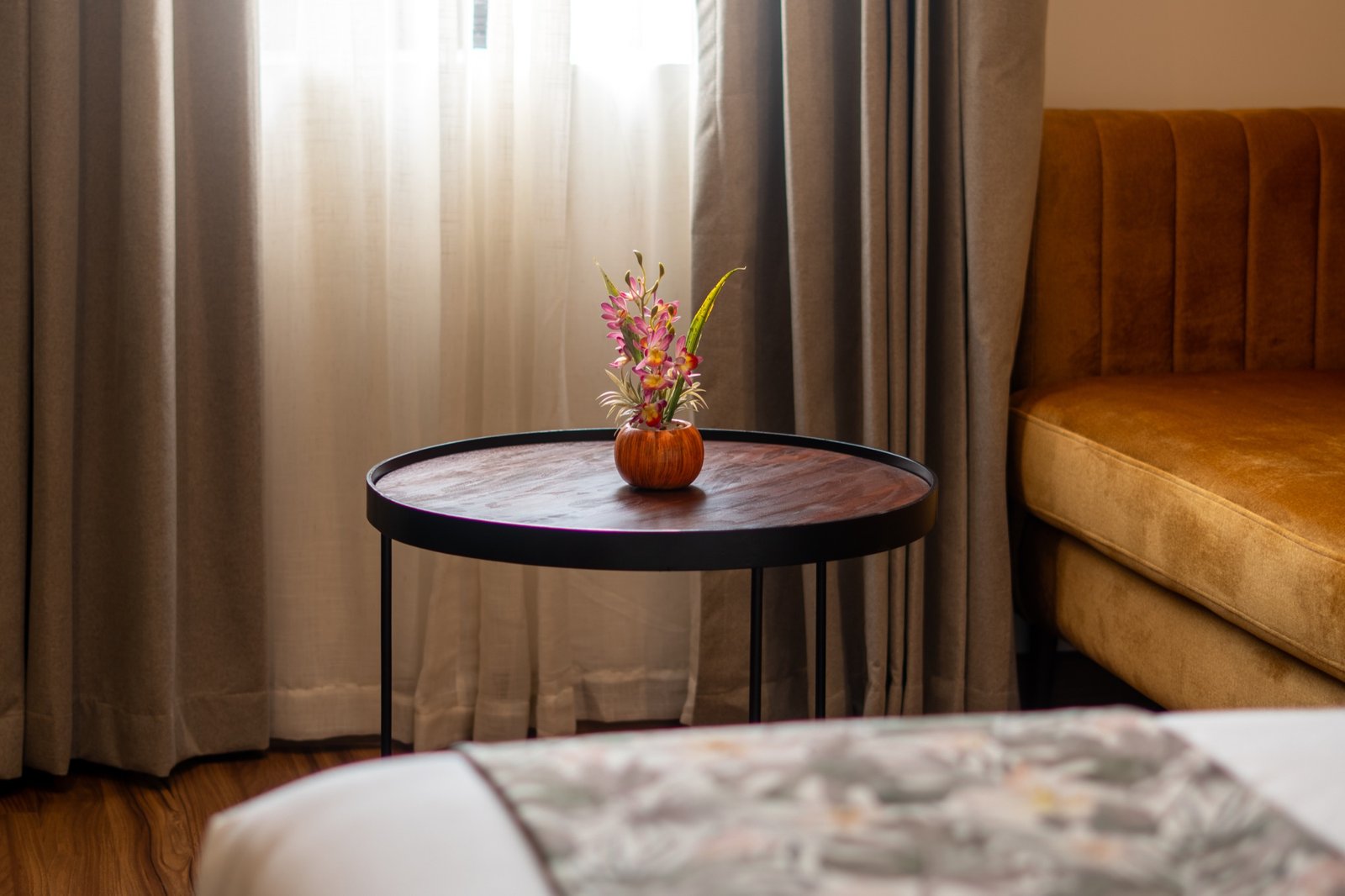 Guest room lounge chair and floral table detail