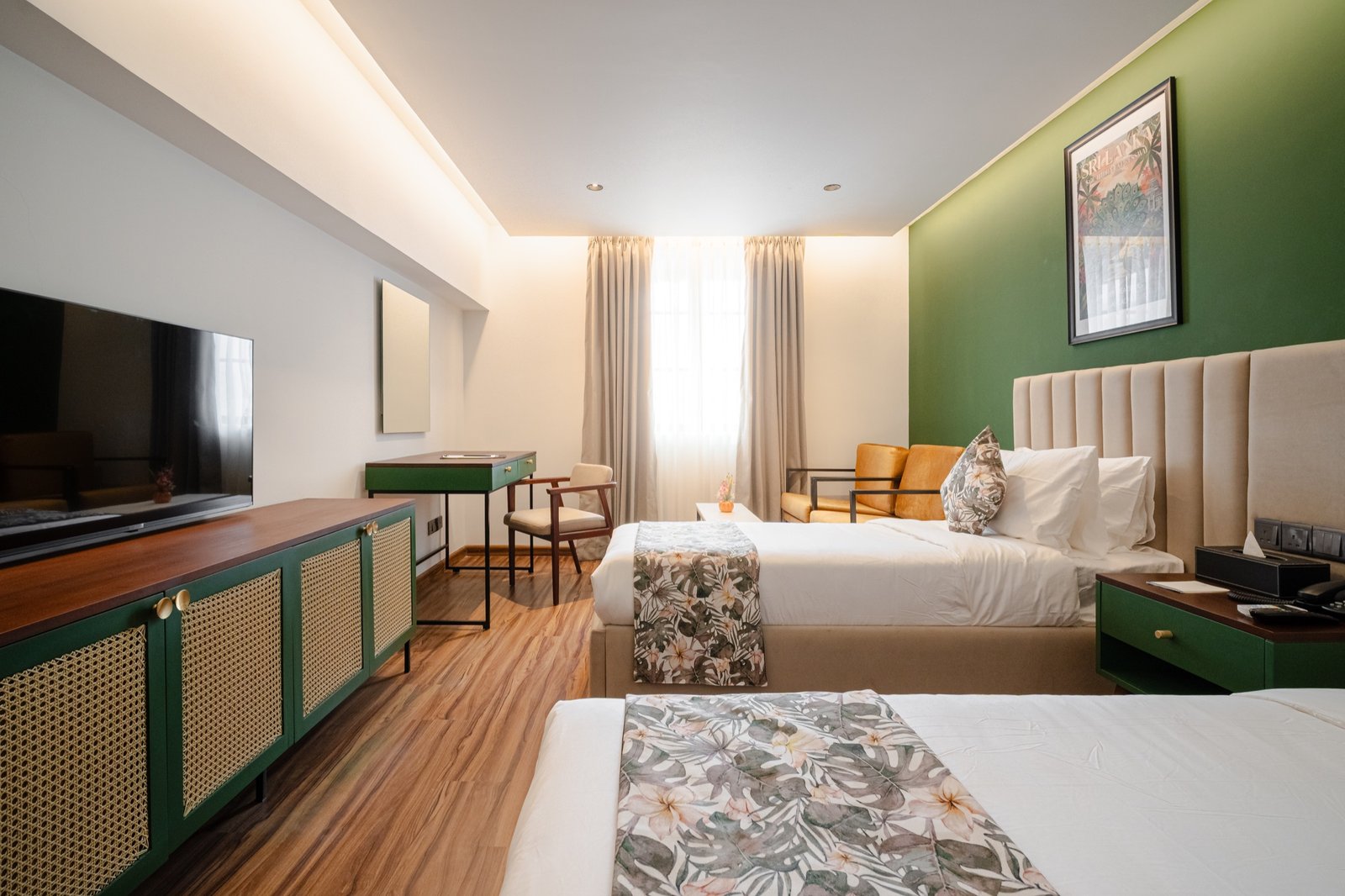 Spacious twin room with green feature wall