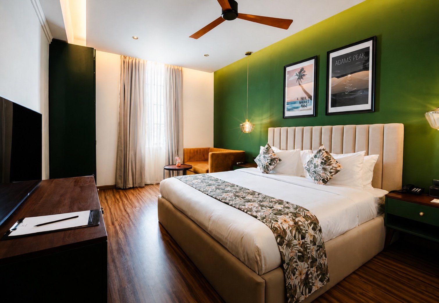 Deluxe Double Room with king bed and green feature wall at MK Colombo
